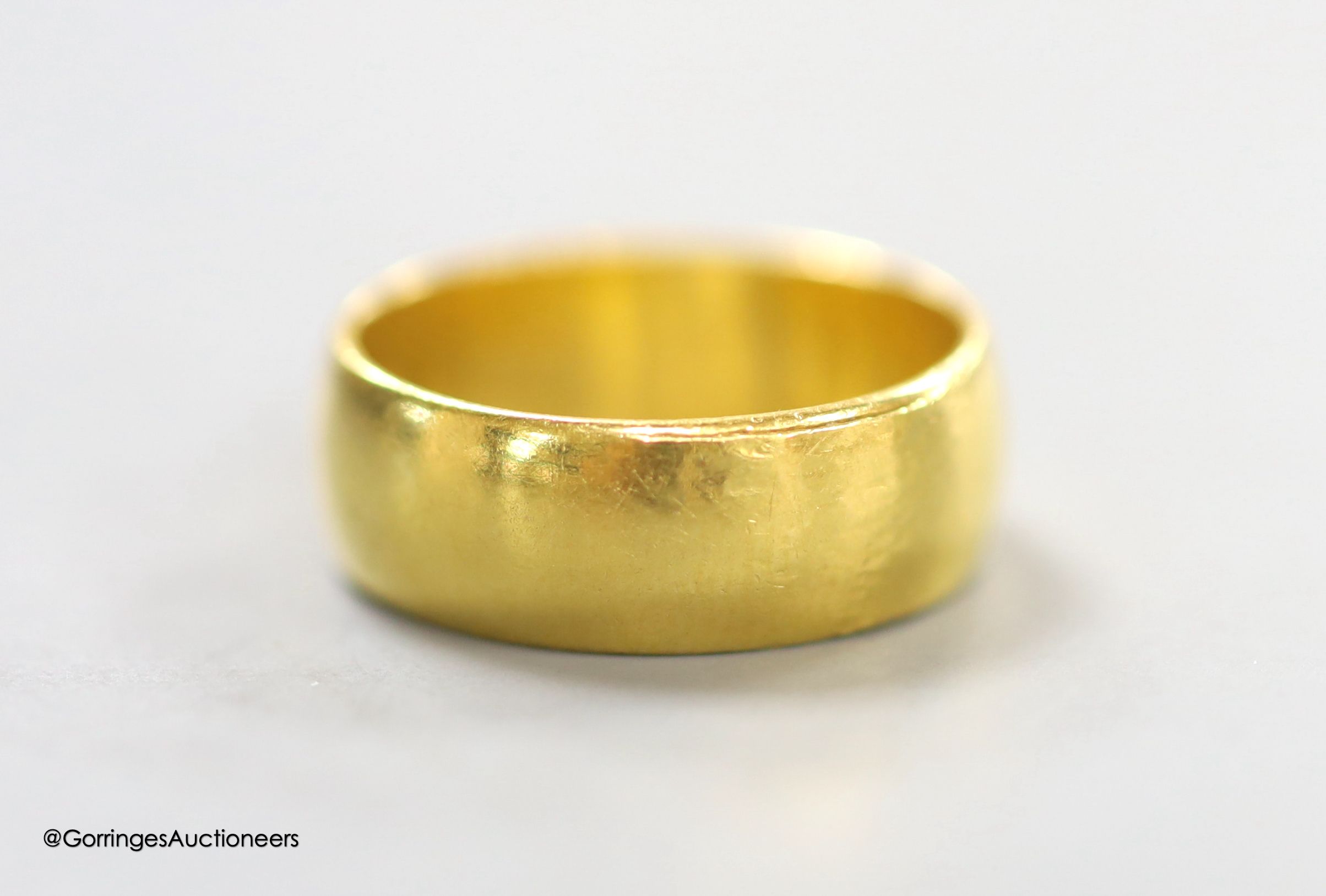 A 22ct gold wedding band, size M, 6.5 grams.